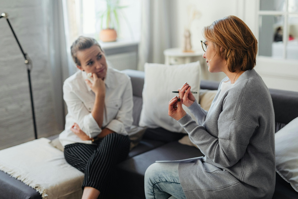 A life coach providing supportive guidance to a client during a stress coaching conversation.