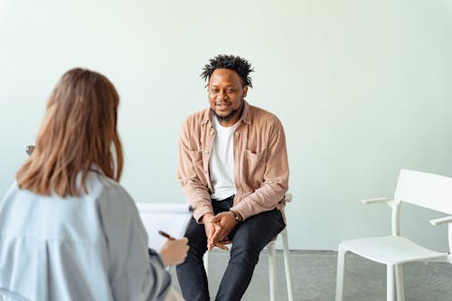 A professional man discussing stress management strategies with a life coach during a one-on-one session